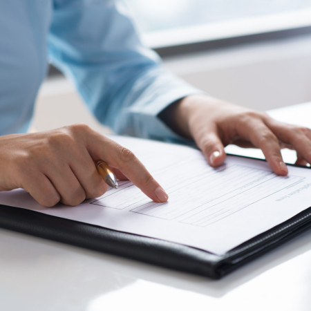 closeup-person-reading-studying-document-scaled (1)